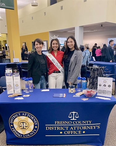 District Attorney Chief of Investigations Lisa Biggs and (left) and Public Information Officer Taylor Long (right) join Miss Clovis Teen (center) for the CART Career Fair.