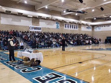 District Attorney Smittcamp speaks to students in school gym.